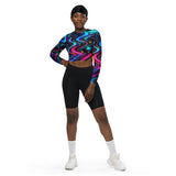Rave-ready and gym-perfect, the model sports the Neon Bliss Long Sleeve Rave Crop Top from Prism Raves, radiating in neon glory suitable for electrifying festival nights and intense gym sessions. This eco-chic crop top, designed with a snug, supportive double-layered waistband and dynamic raglan sleeves, is crafted from premium recycled materials, emphasizing both style and sustainability. Ideal for EDM lovers and fitness enthusiasts aiming to stand out while supporting eco-friendly fashion.