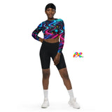 Rave-ready and gym-perfect, the model sports the Neon Bliss Long Sleeve Rave Crop Top from Prism Raves, radiating in neon glory suitable for electrifying festival nights and intense gym sessions. This eco-chic crop top, designed with a snug, supportive double-layered waistband and dynamic raglan sleeves, is crafted from premium recycled materials, emphasizing both style and sustainability. Ideal for EDM lovers and fitness enthusiasts aiming to stand out while supporting eco-friendly fashion.